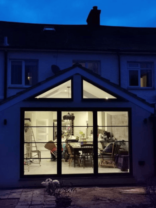 ddb30c77-8fda-4943-ac82-80534510d04a-3 Rear house extension featuring sliding glass doors.